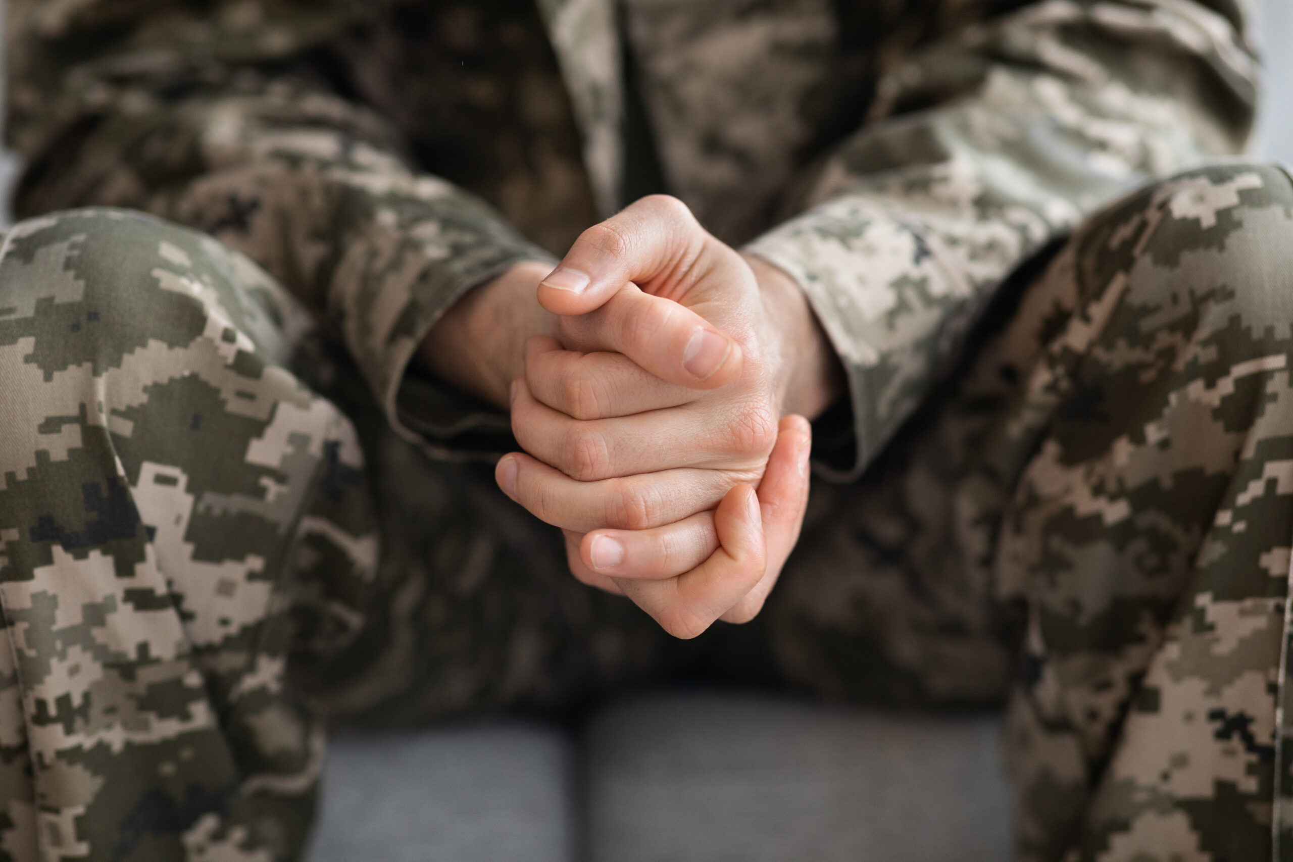 Sitting Marine with clasped hands