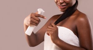 Woman using hair relaxer