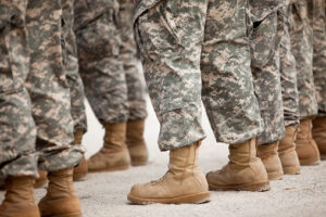 Rows of Marines in fatigues standing at ease.