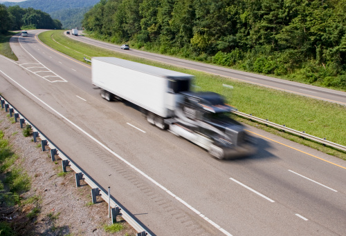 Semi-truck going at full speed down a highway