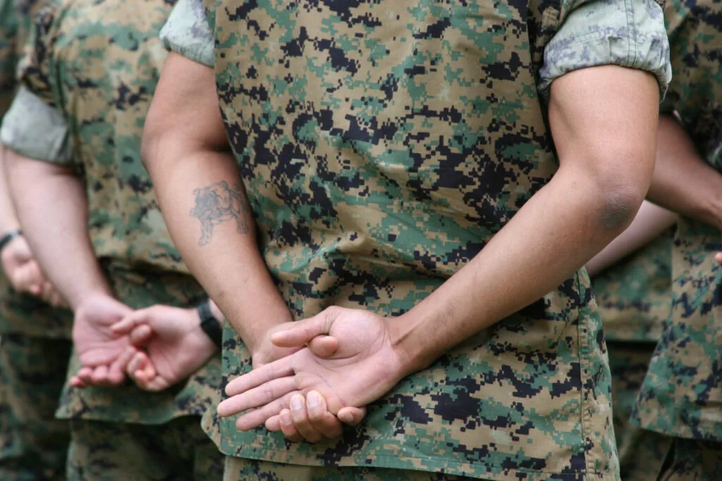 African American Marine in formation with a tattoo