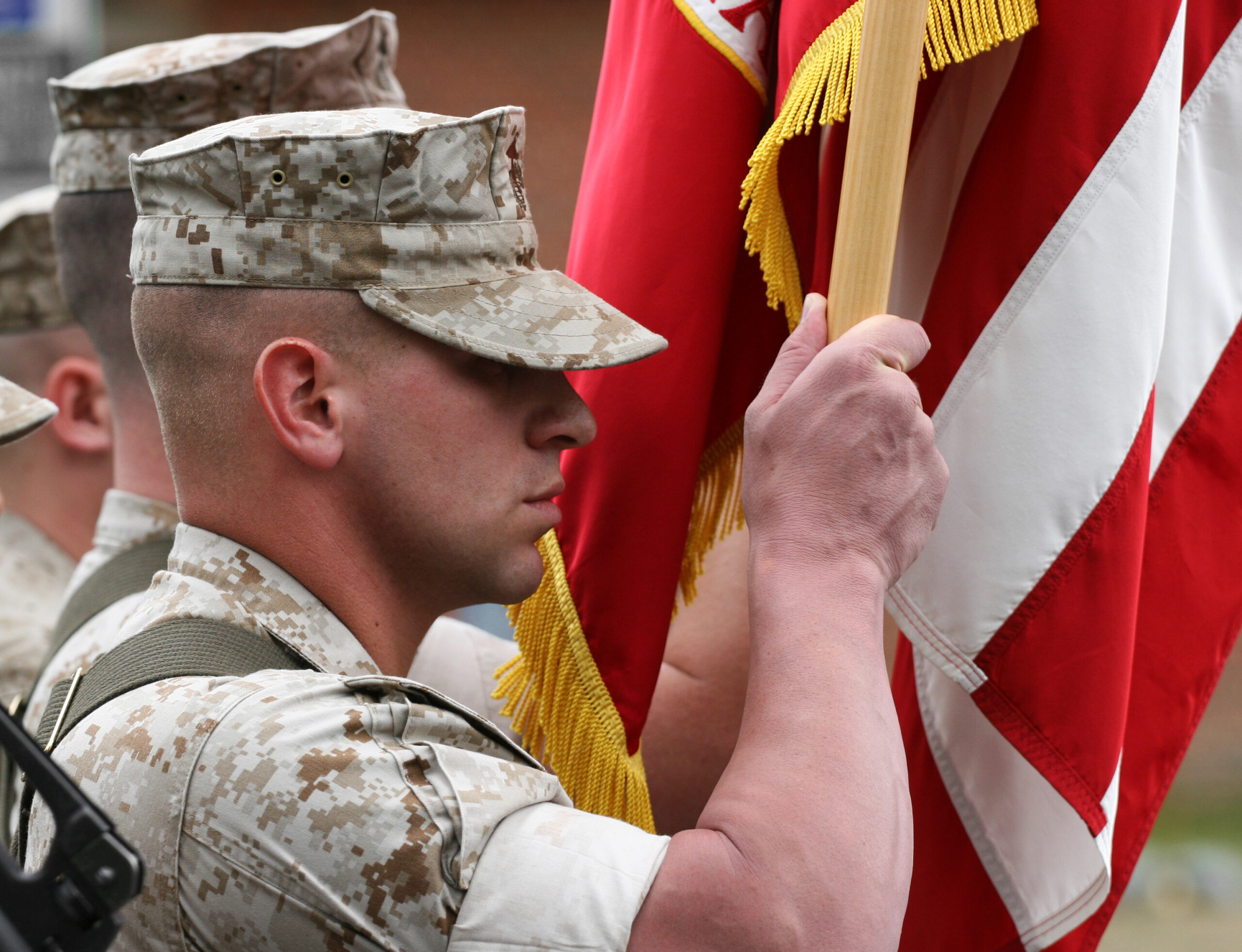 Marine carrying Marine Corps flag.