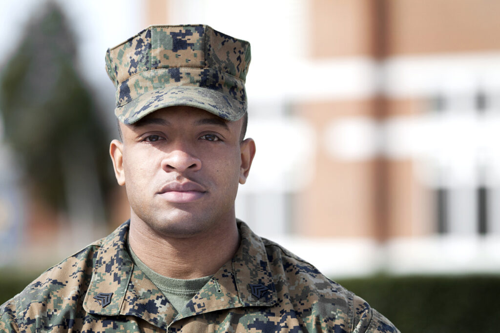 Marine headshot, man dressed in camo fatigues