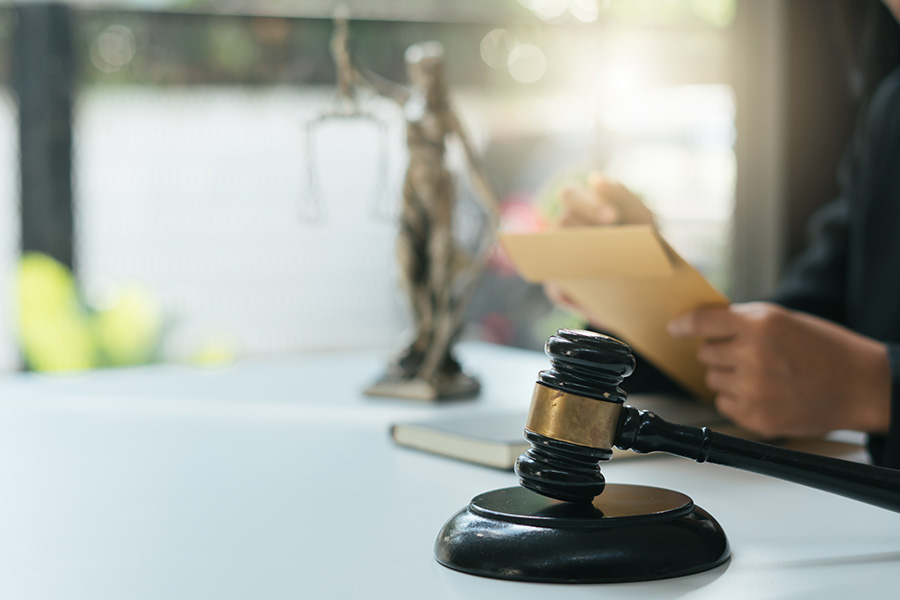 lawyer with envelope and gavel in foreground