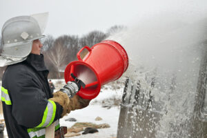 Female firefighter using foam