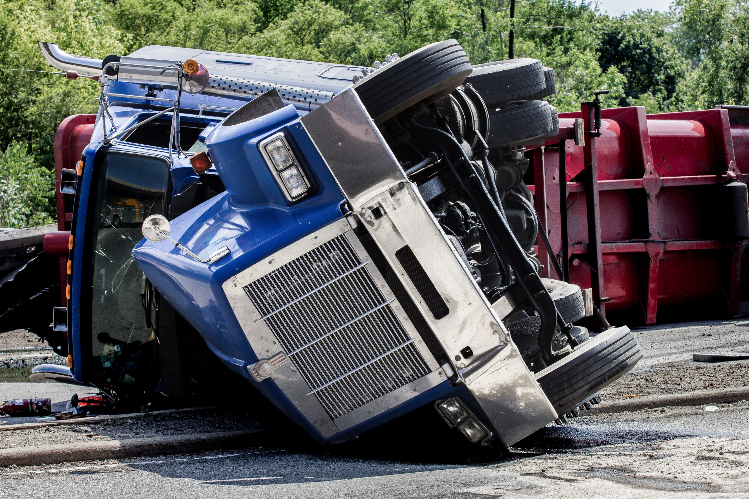 Jackknifed rig on its side on a highway