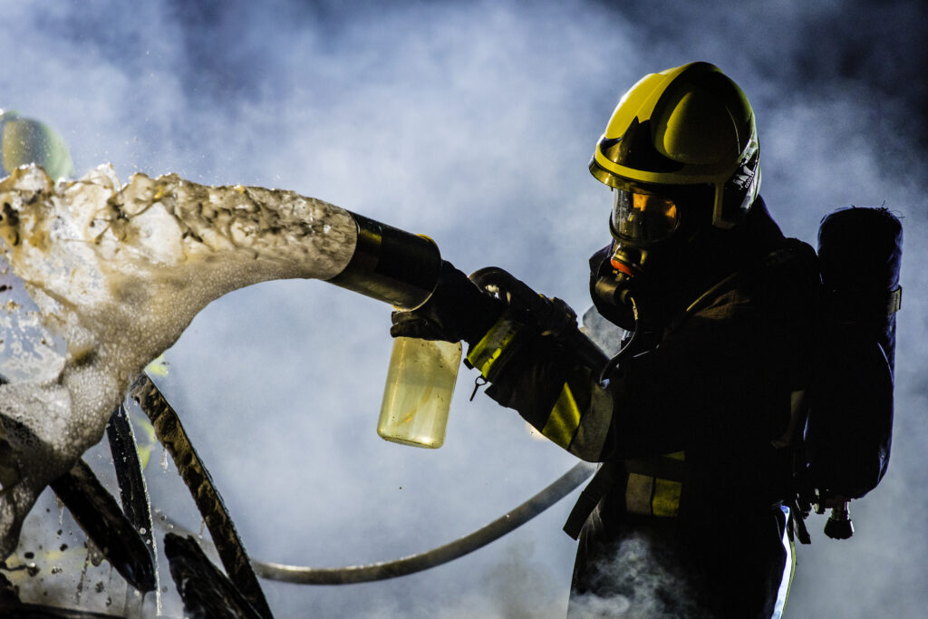 Firefighters spraying AFFF