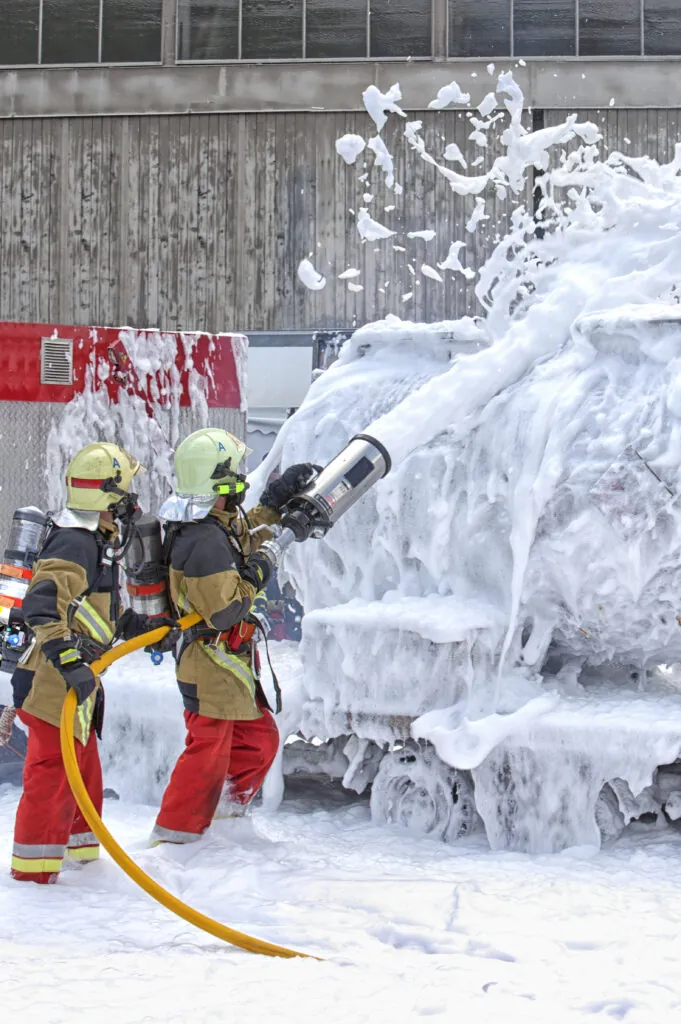 Firefighters spraying AFFF