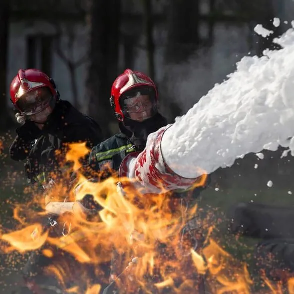 Firefighters spraying AFFF